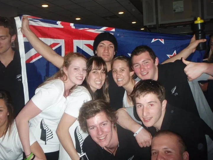 Celebrating with the New Zealand team in front of the flag